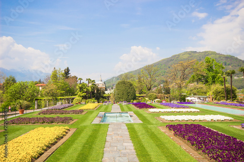 Spring landscape with colorful flowers, Beautiful view of amazing tropical scenery with bright day blue sky and clouds in spring nature background, Landscape Gardens of Villa Taranto, Lago Maggiore.
