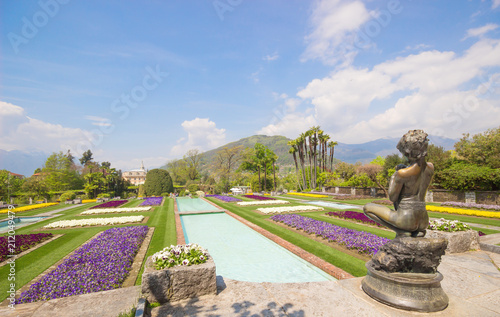 Spring landscape with colorful flowers, Beautiful view of amazing tropical scenery with bright day blue sky and clouds in spring nature background, Landscape Gardens of Villa Taranto, Lago Maggiore.