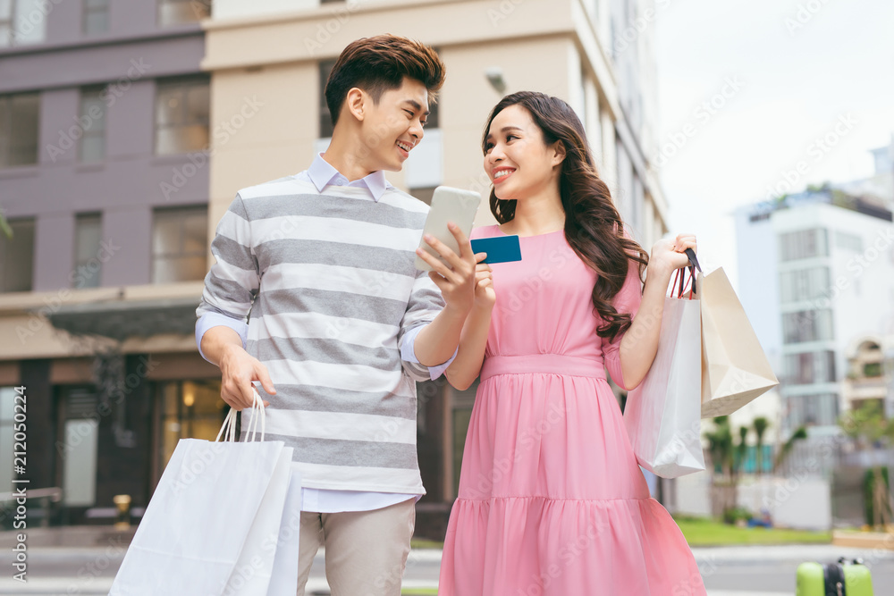 Φωτογραφία Beautiful asian couple shopping with a credit card in the city