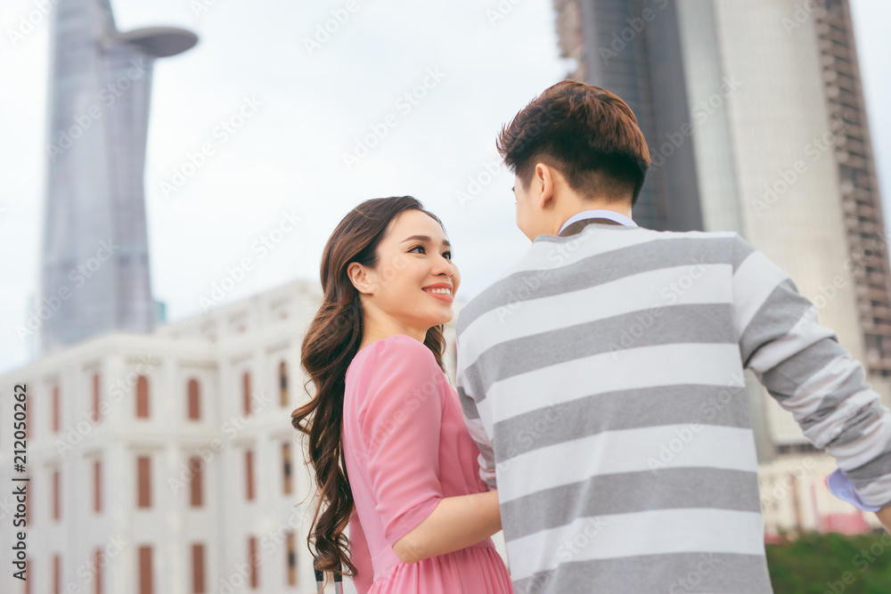 Young lovers walking around city on vacation, enjoying traveling together, outdoors. Young lovers walking around city on vacation, enjoying traveling together, outdoors.