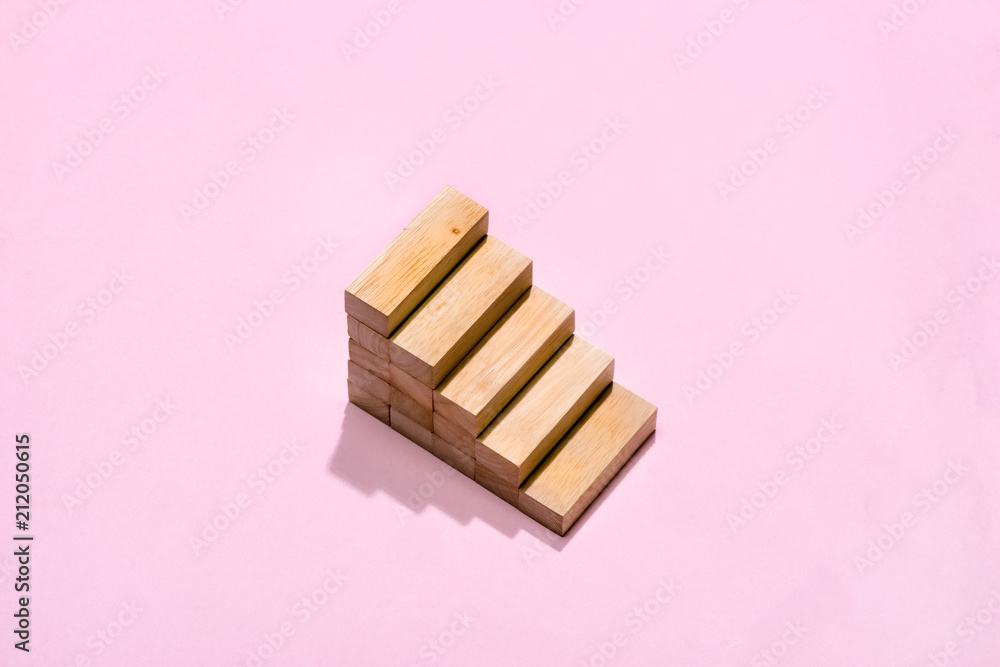 Concept of building success foundation. Wooden blocks in the shape of a staircase Concept of building success foundation. Wooden blocks in the shape of a staircase