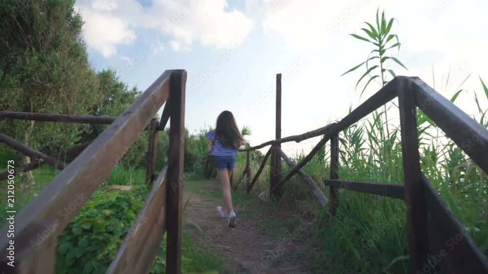 Summer - Spring: little girl with long hair climbs the stairs and runs happy in the park to watch the sea
Summer - Spring: little girl with long hair climbs the stairs and runs happy in the park to watch the sea