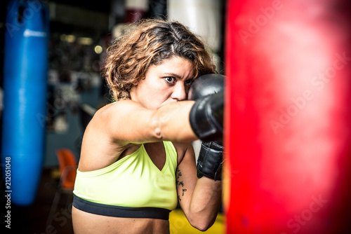 Boxer woman training at the heavy bag