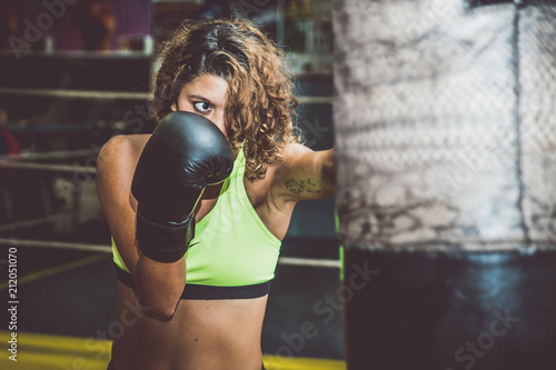 Boxer woman training at the heavy bag