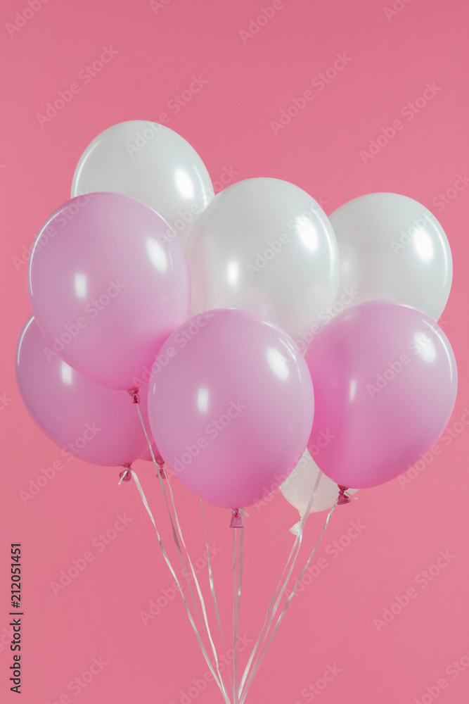Decorative white and pink balloons isolated on pink