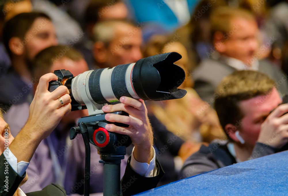 Professional photographer works at business conference