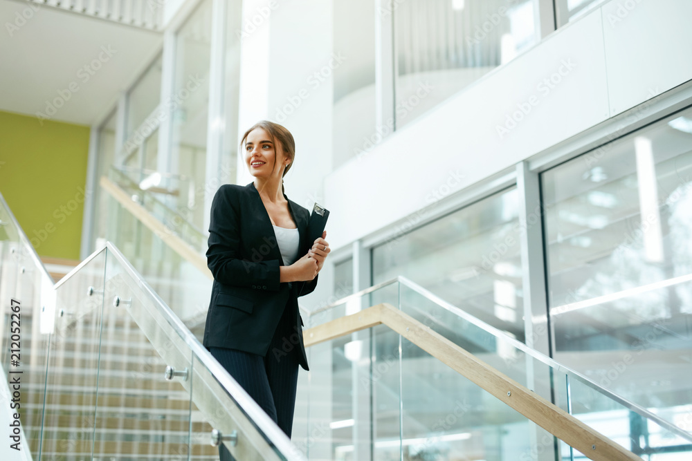 Business Woman In Office Interior. Female Worker Business Woman In Office Interior. Female Worker