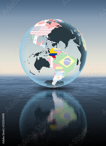 Fototapeta Naklejka Na Ścianę i Meble -  Colombia on globe with flags above water