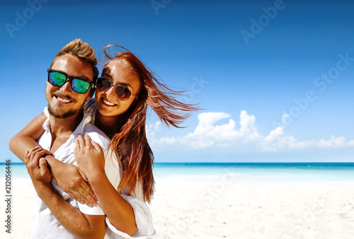 Summer trip on beach. Two lovers and sea landscape with blue sky. Free space for your text. 