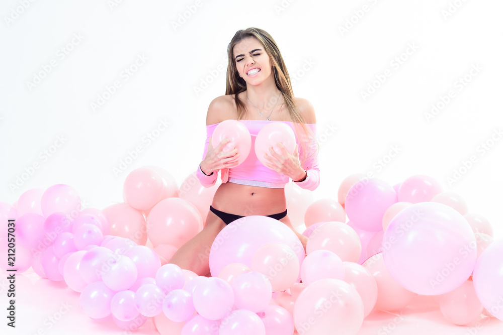 Trendy young woman posing in pink balloons. Party girl, happy mood, celebration concept. Smiling girl sit with balloons. Sexy girl with long hair posing with pink balloons. Party mood. Trendy young woman posing in pink balloons. Party girl, happy mood, celebration concept. Smiling girl sit with balloons. Sexy girl with long hair posing with pink balloons. Party mood.