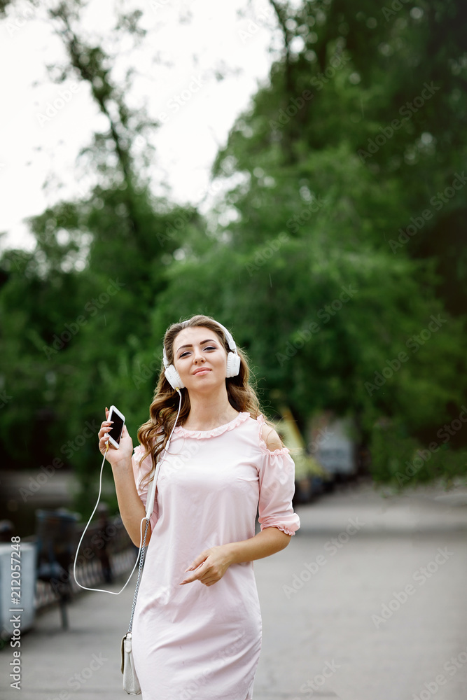 young woman listening to music on headphones