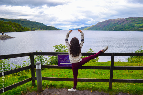 Ballet ballerina dancing in front of Loch Ness, in Highlands (Scotland, United Kingdom)