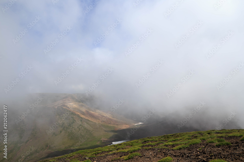 Clouds over valley on summit of Mt. Asahi in Hokkaido, Japan