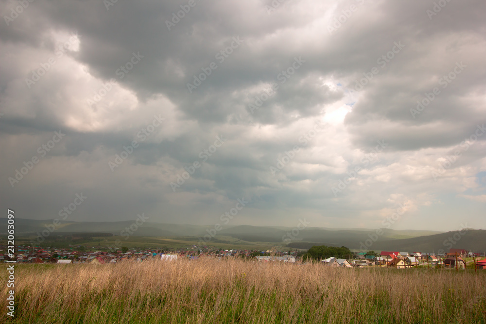 scenic view with dark stormy sky and countryside