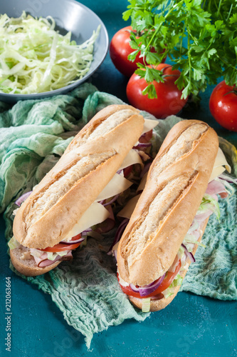 Submarine sandwiches with ham, cheese and vegetables