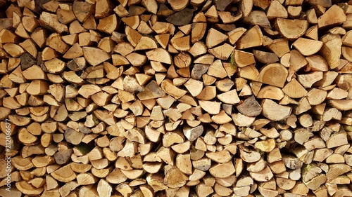 Close up image of cut firewood logs stacked in a pile
