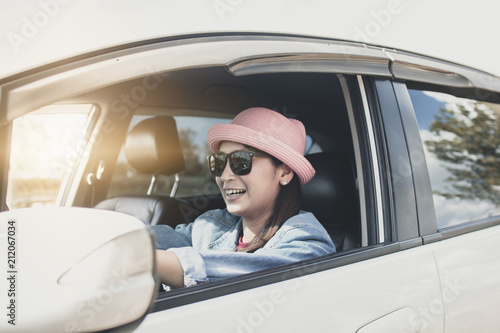happy and funny woman driving car
