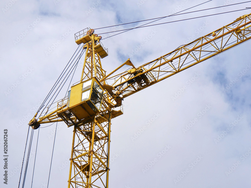 Construction crane against cloudy sky.