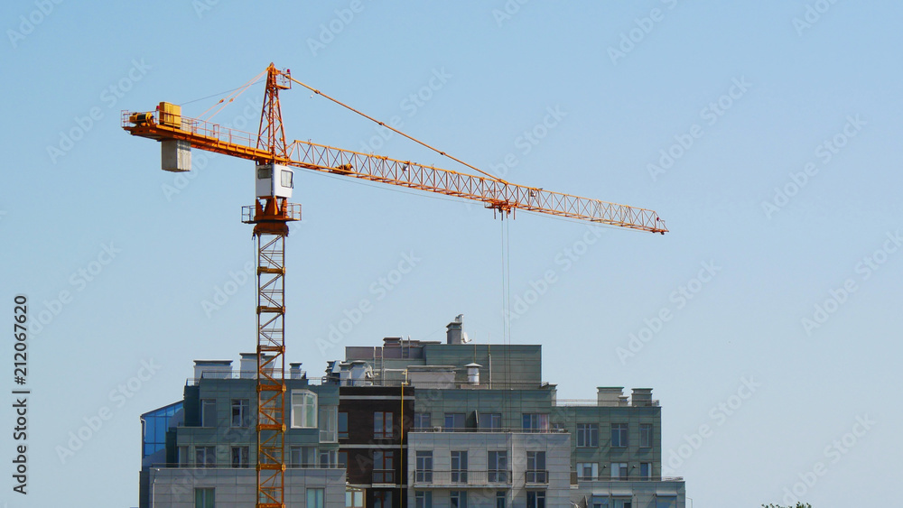 Crane near building. Building under construction. Crane near building. Building under construction.