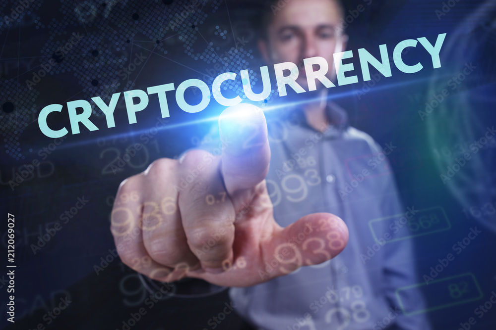 The concept of business, technology, the Internet and the network. A young entrepreneur working on a virtual screen of the future and sees the inscription: Cryptocurrency The concept of business, technology, the Internet and the network. A young entrepreneur working on a virtual screen of the future and sees the inscription: Cryptocurrency