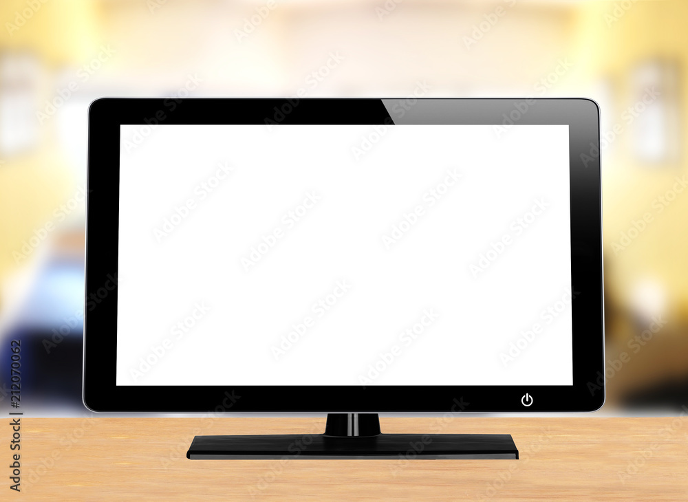 computer monitor on wooden table over bright background computer monitor on wooden table over bright background