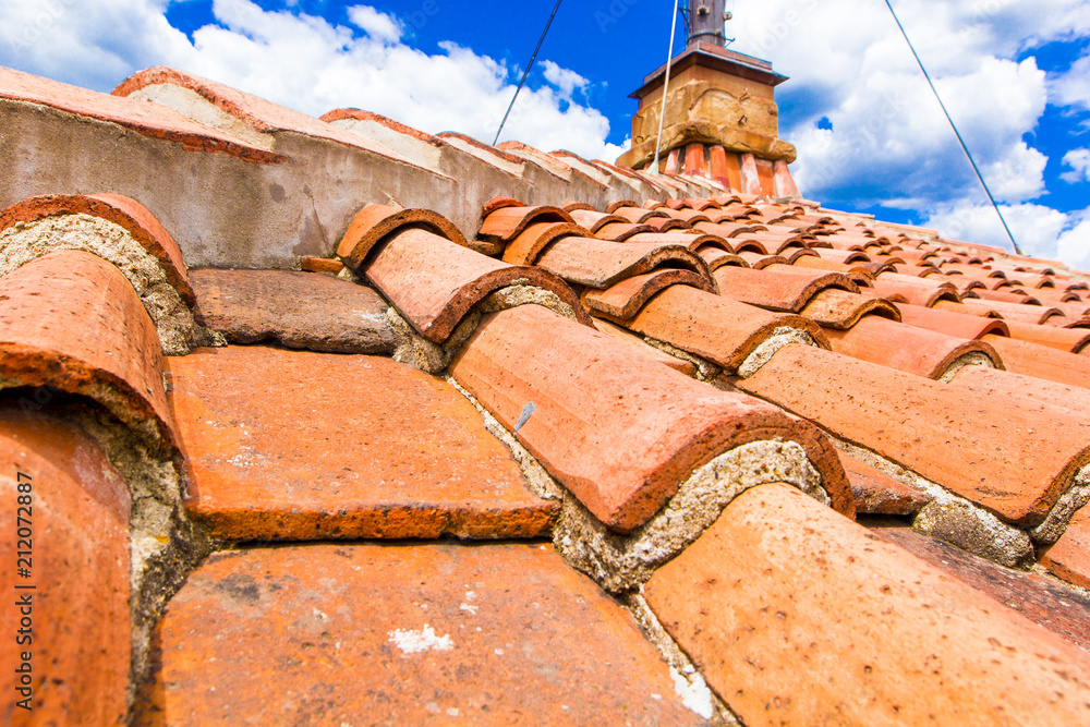 Old red brick roof tiles from north on roofs of Italian houses and