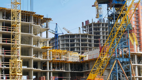 Industrial background. Work on the construction site. Hoisting cranes and building activity. © fotolian121212