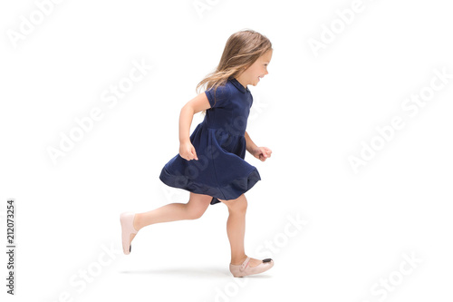 Smiling cute toddler girl three years running over white background