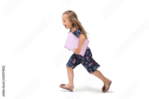 Smiling cute toddler girl three years running over white background