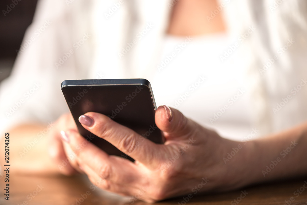 Woman's hands using a mobile phone