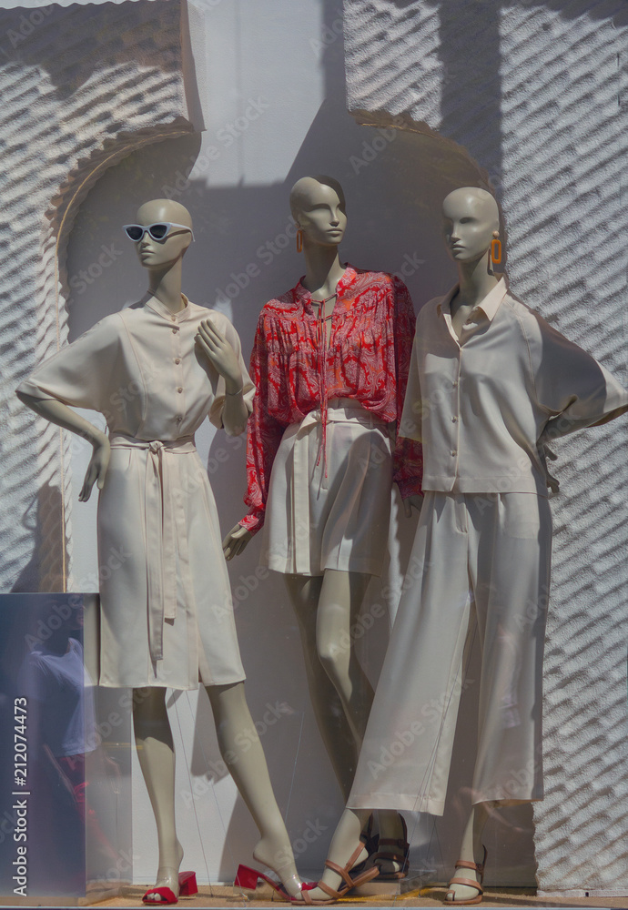 Female mannequins in trendy clothes in the shop window