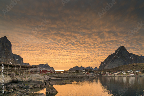 The fishing harbour of Reine and stockfish plantations at Lofoten Islands / Norway at sunset
