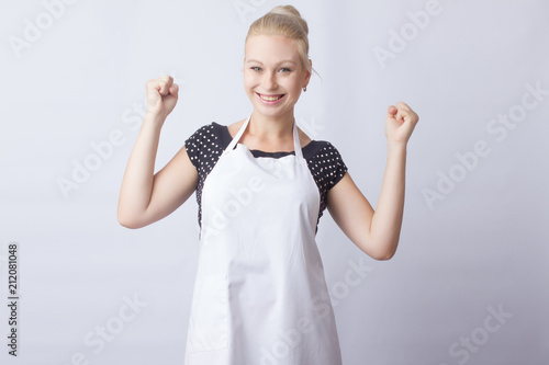 Fotografering cute blonde woman in white apron posing on white background