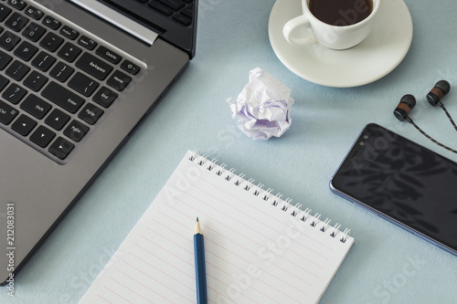 Workplace. Notebook, pencil, laptop, smartphone, headphones, cup of coffee. Close up.  Business, education concept. Morning time