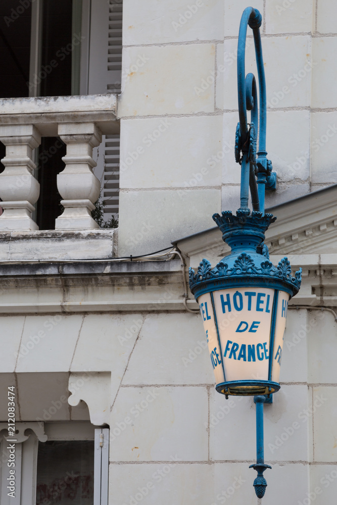 Ornate blue ironwork Hotel of France sign in Loches, France Ornate blue ironwork Hotel of France sign in Loches, France