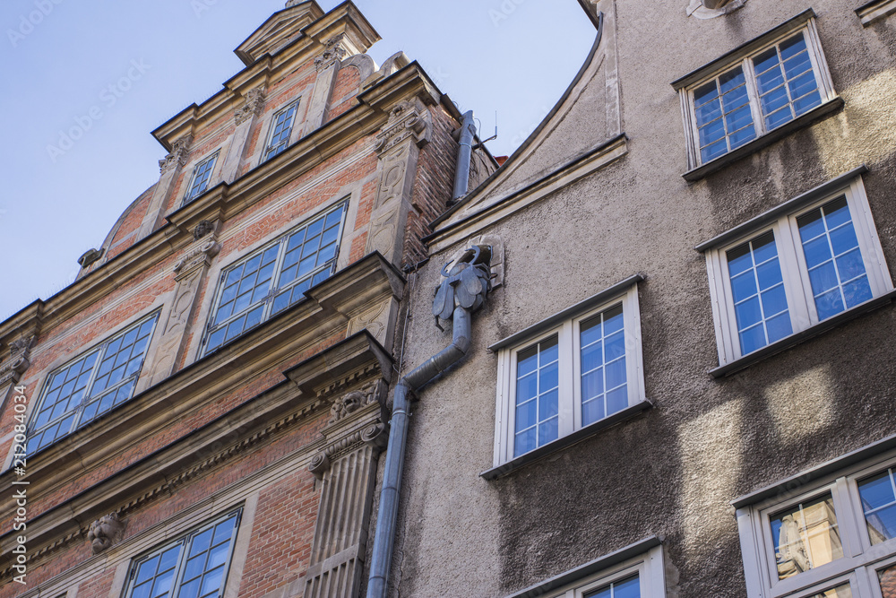The facade of the beautiful historic building on the street of the Old Town of Gdansk. Poland