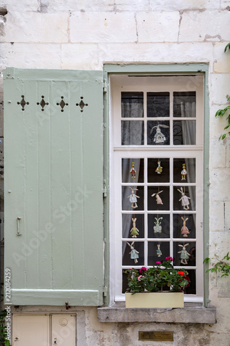 Rabbit toys in a french window in Loches  France