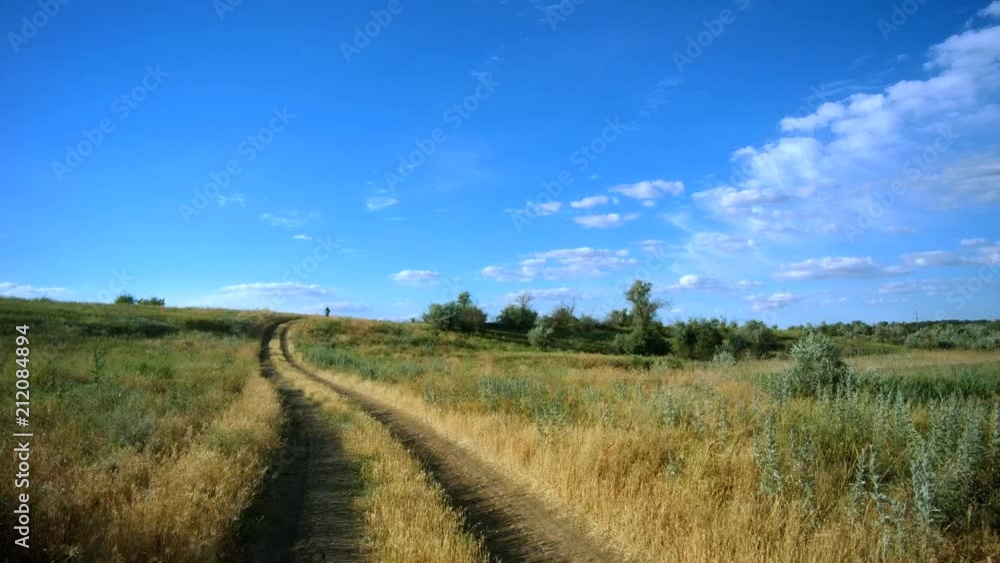 male tourist on a bicycle driving along a country road male tourist on a bicycle driving along a country road