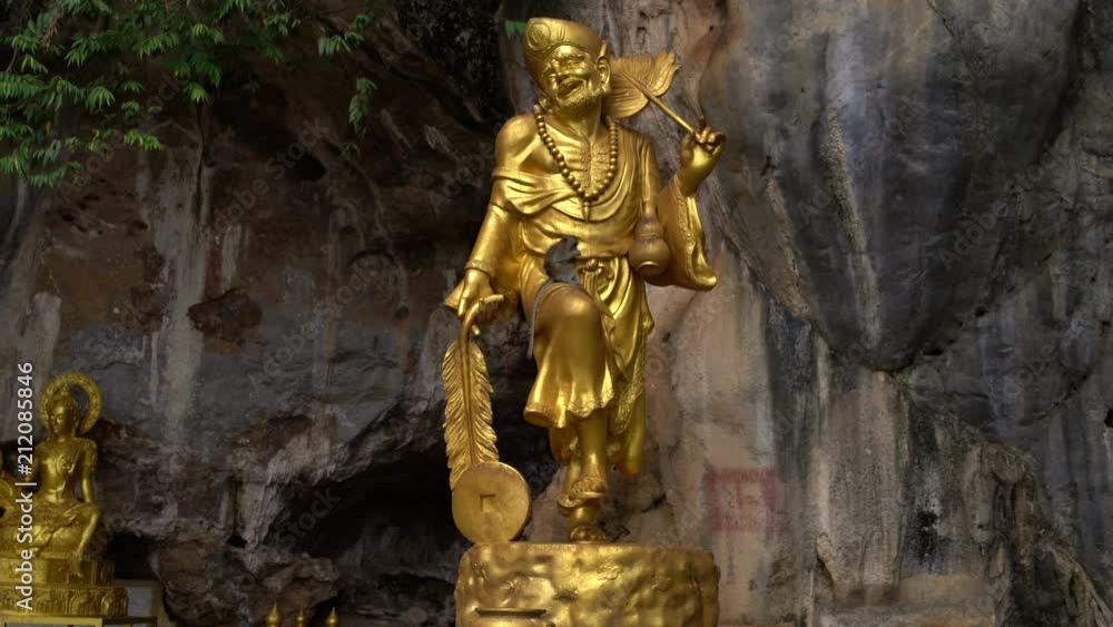 On the golden statue of the deity sits a monkey On the golden statue of the deity sits a monkey