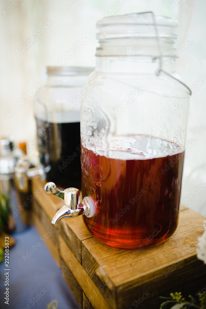 Morse in a glass bottle with a tap Morse in a glass bottle with a tap
