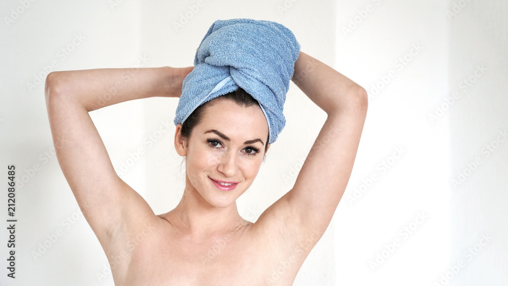 young woman with shaved armpits and towel turban after shower, body care concept with copy space young woman with shaved armpits and towel turban after shower, body care concept with copy space