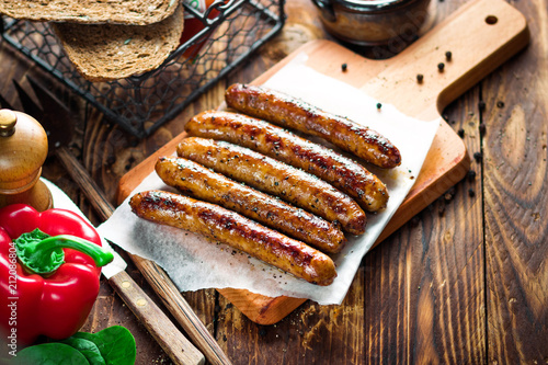 Pork chipolata. Close-up view of fried sausages. Meat dish