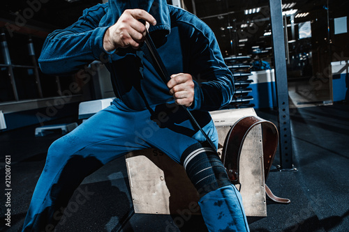 Strong man working in gym photo