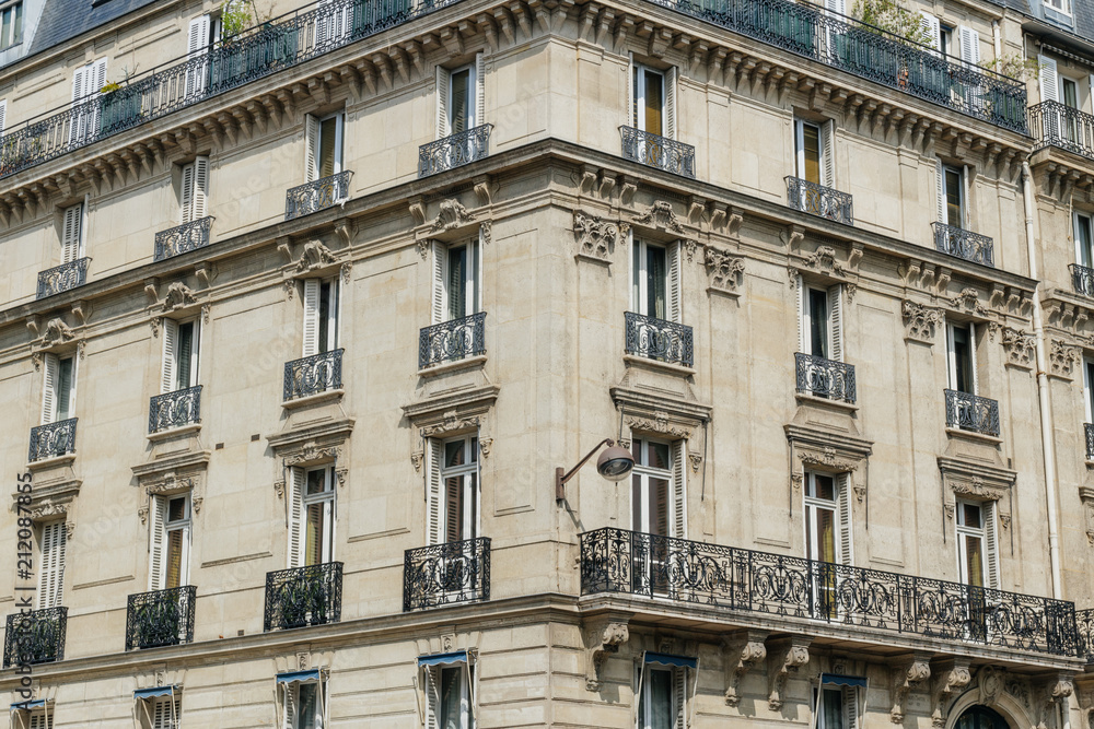 Paris residential buildings. Old Paris architecture, beautiful facades, typical french houses. Famous travel destinations in Europe. Backgrounds. City life, lifestyle and expensive real estate concept