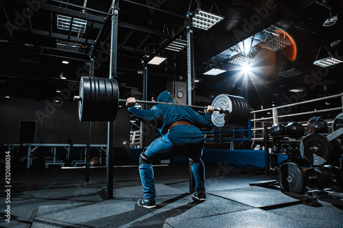 Strong man working in gym photo