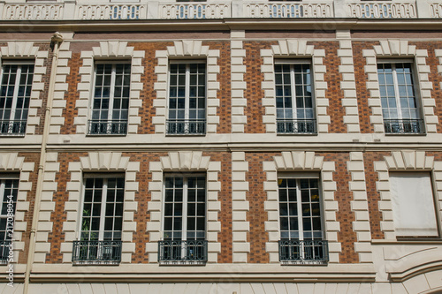 Paris residential buildings. Old Paris architecture, beautiful facades, typical french houses. Famous travel destinations in Europe. Backgrounds. City life, lifestyle and expensive real estate concept