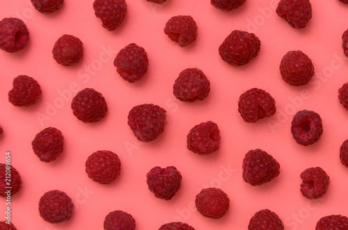 Background of ripe juicy berry raspberries in the style of pop art on pink.