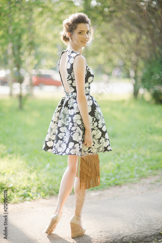 a girl in a summer dress looking back
