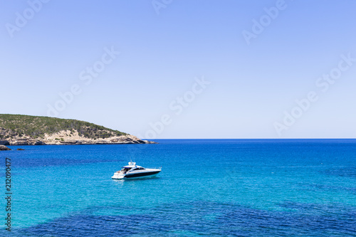 beautiful landscape in Ibiza of blue ocean in a sunny day with boats in the horizon. Summer and holidays concept.