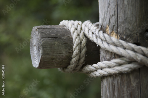 rope around wooden beams © Amy